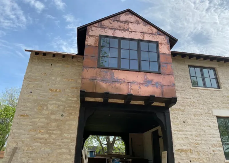 Copper metal panel facade on a stone building for Skylight Installation in Manassas